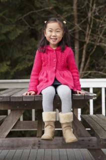 Korean girl sitting on picnic bench