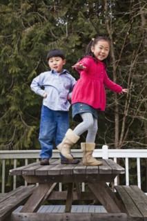 Korean children playing on picnic bench