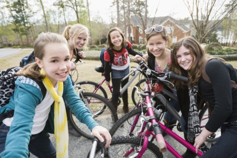 Caucasian friends on bicycles