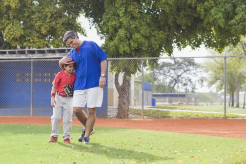 Hispanic coach and young baseball player