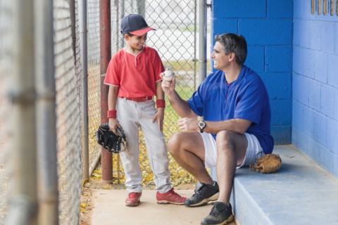 Hispanic coach and young baseball player