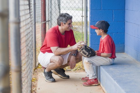 Hispanic coach and young baseball player
