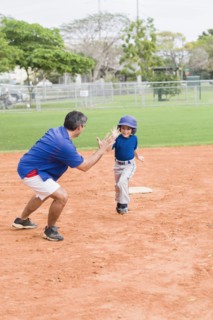 Hispanic coach and young baseball player