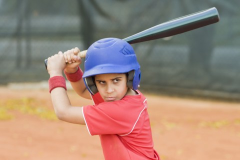 Hispanic baseball player about to swing