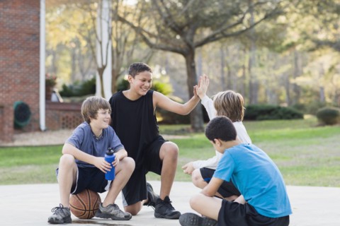 Boys sitting with basketball