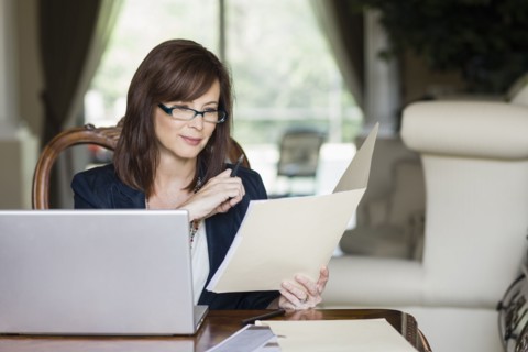 Caucasian businesswoman looking at paperwork