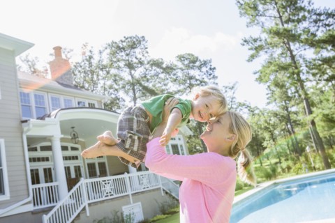 Caucasian mother and son playing in backyard