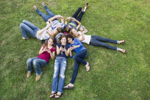 Friends hanging out together on grass