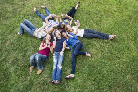 Friends hanging out together on grass