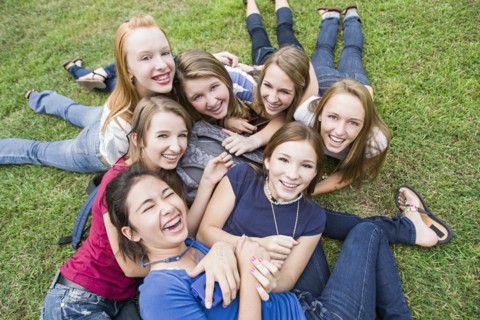 Friends hanging out together on grass
