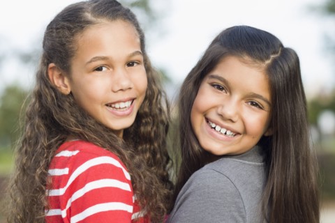 Smiling girls walking outdoors
