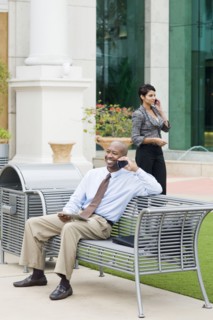 Business people talking on cell phones outdoors