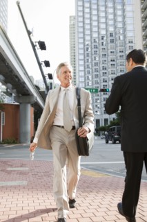 Caucasian businessman walking on city street