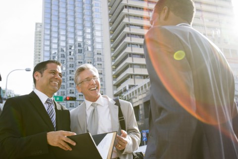 Businessmen talking on city street