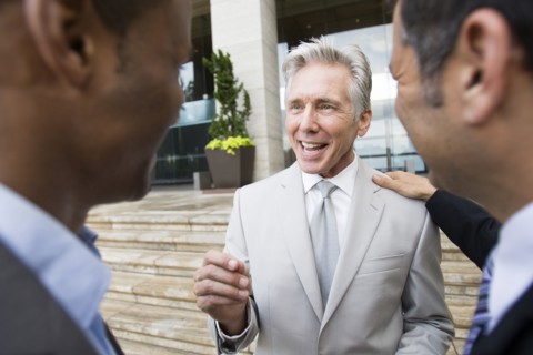 Businessmen talking on city street