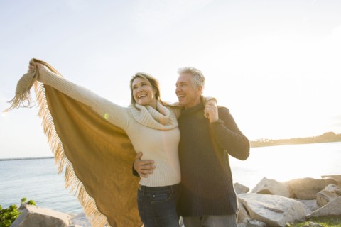 Caucasian couple walking by lake