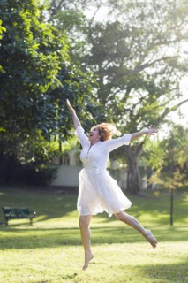 Hispanic woman dancing outdoors