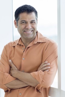 Hispanic man smiling in window