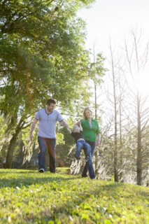 Caucasian family walking in park