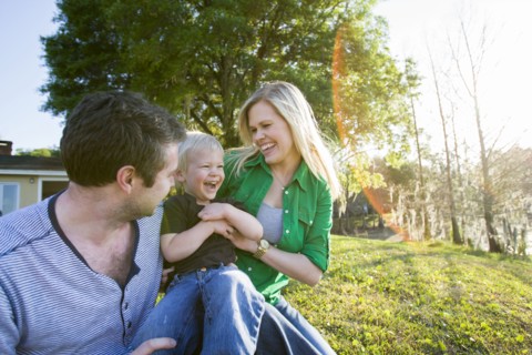 Caucasian family relaxing in backyard