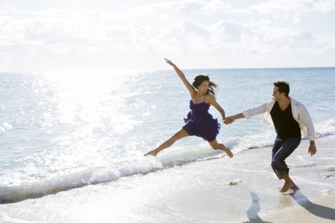 Couple playing in surf on beach
