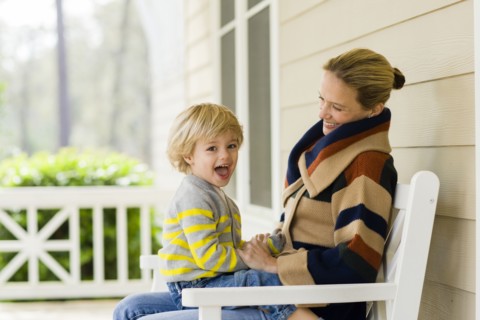 Caucasian mother holding son