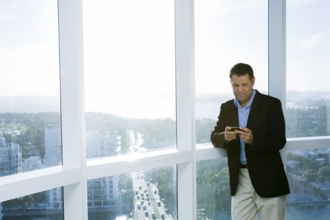 Hispanic businessman using cell phone