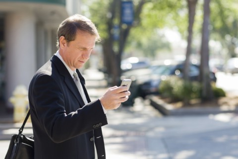 Caucasian businessman using cell phone