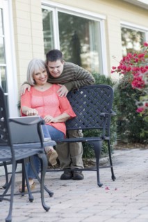 Caucasian mother and son using laptop outdoors