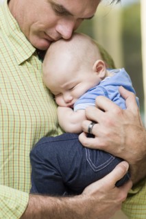Caucasian father holding baby boy
