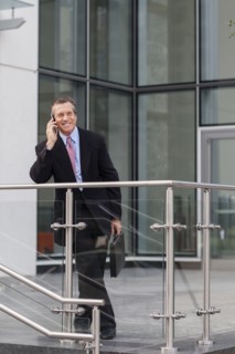 Caucasian businessman on cell phone outside building