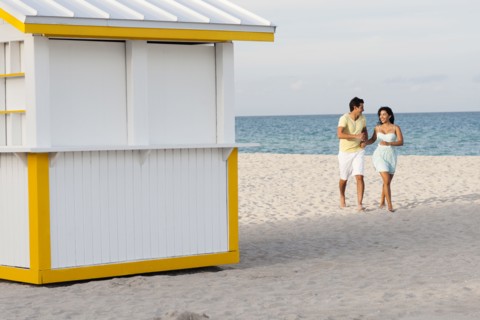 Hispanic couple walking on beach
