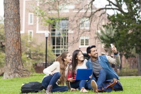 Students taking cell phone photograph on campus