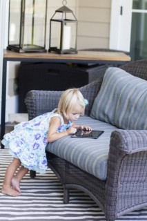 Caucasian girl using digital tablet on sofa