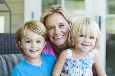 Caucasian mother and children smiling outdoors