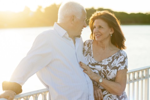 Older Caucasian couple hugging outdoors