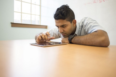 Asian businessman using digital tablet in office