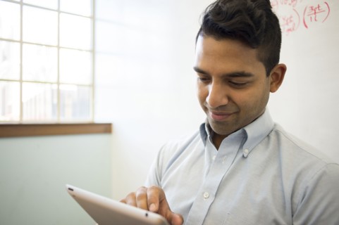 Asian businessman using digital tablet in office