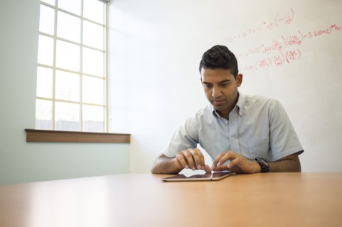 Asian businessman using digital tablet in office