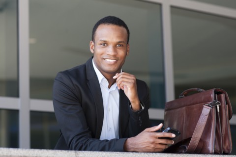 Black businessman using cell phone