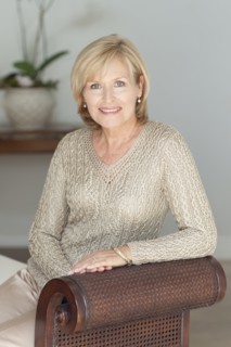 Smiling Caucasian woman sitting on bench