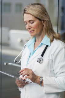 Caucasian doctor using digital tablet in hospital