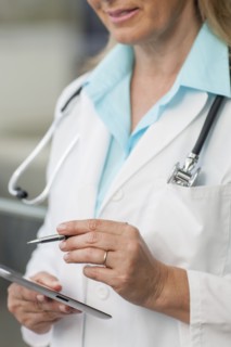 Close up of Caucasian doctor using digital tablet