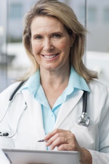 Close up of Caucasian doctor using digital tablet