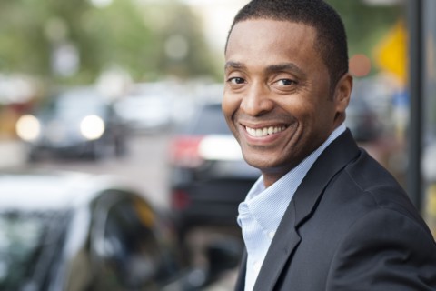 Black businessman smiling in city