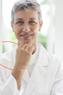 Close up of smiling doctor resting chin in hand