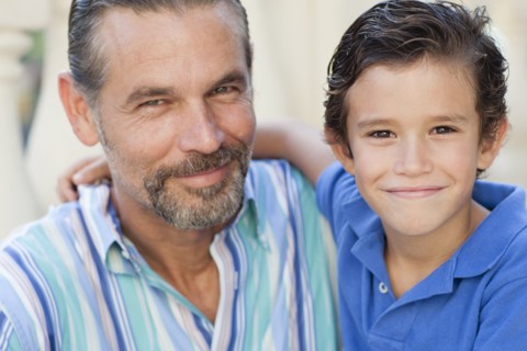 Close up of Caucasian father and son hugging