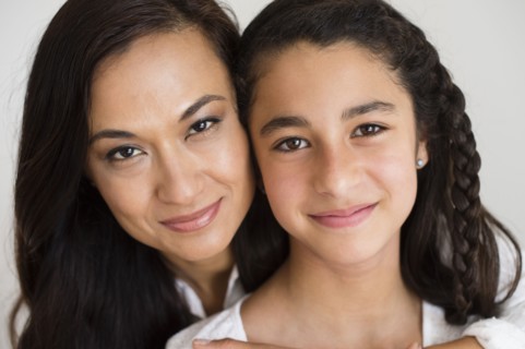 Close up of mother and daughter hugging