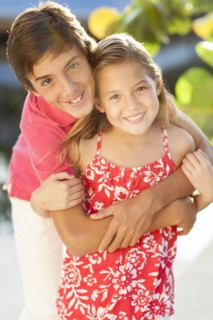 Close up of Caucasian brother and children hugging