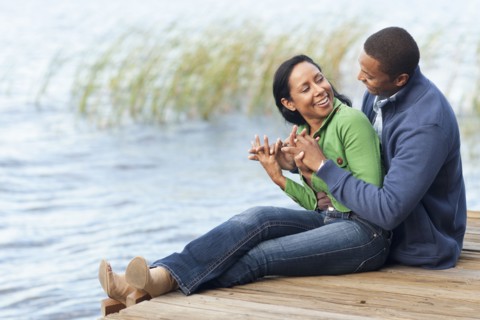 Smiling couple hugging at dock